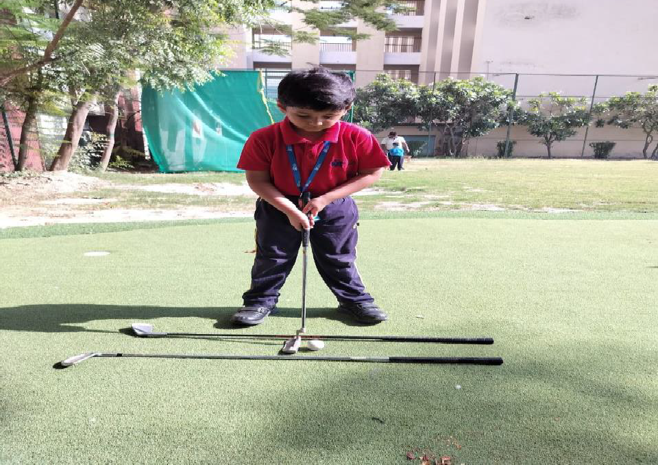 Students practicing golf